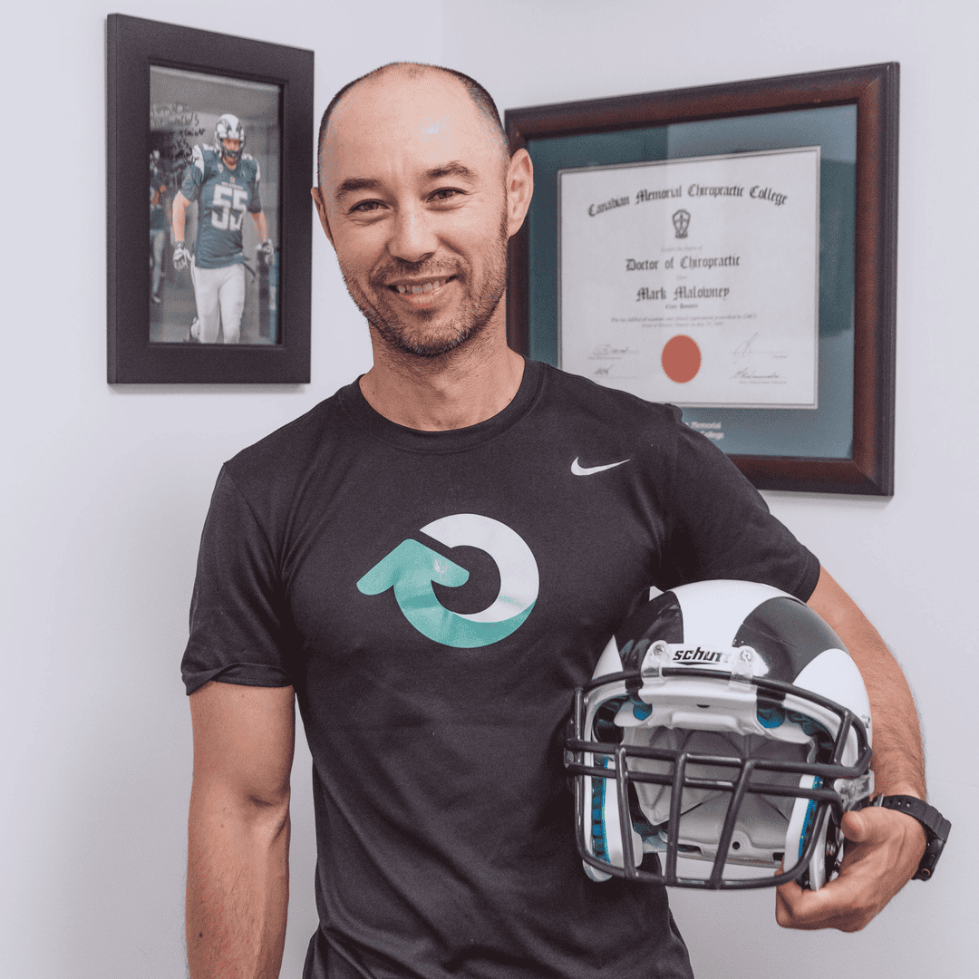 Dr Mark Langley Chiropractor Holding Football Helmet